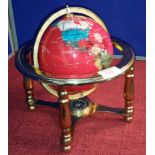 Precious stone globe on brass support stand, 24cm tall