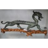 Cold painted bronze dragon figure on hardwood stand, 16.5x36cm