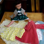 1950's Doll together with a selection of dolls clothes