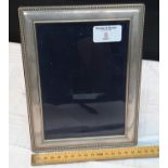 Silver hall marked photo frame. 21.5cm high.