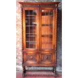 Large oak display cabinet with barley twist edging & supports with glass & lead double doors