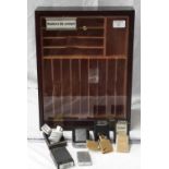 Smokers display cabinet, together with various Zippo lighters