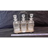 Silver plated tantilis with 3 decanters & whisky, sherry & brandy labels