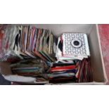 A large box of 45 RPM's containing mixed genres