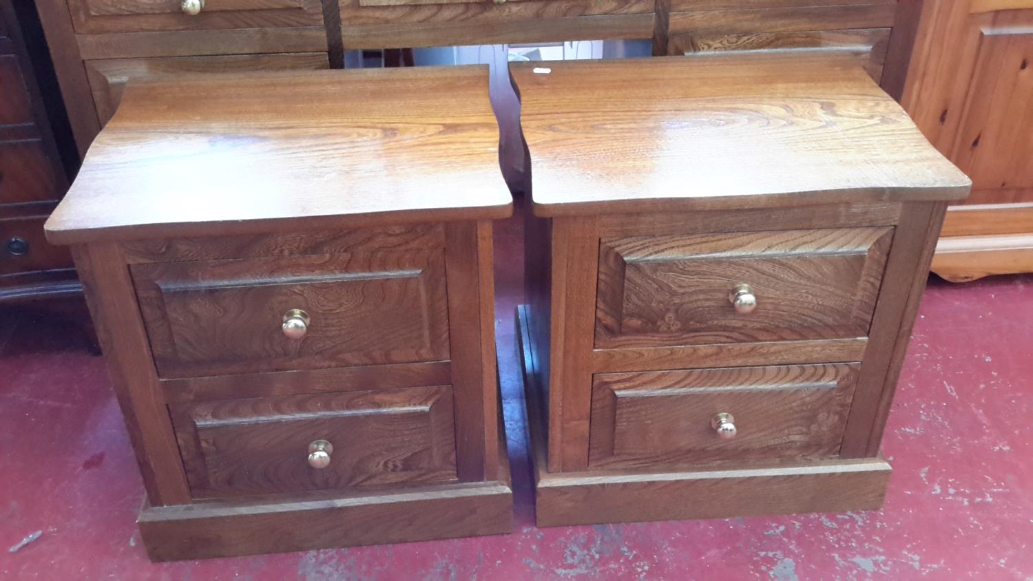 A matching pair of solid oak bedside cabinets