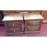 A matching pair of solid oak bedside cabinets