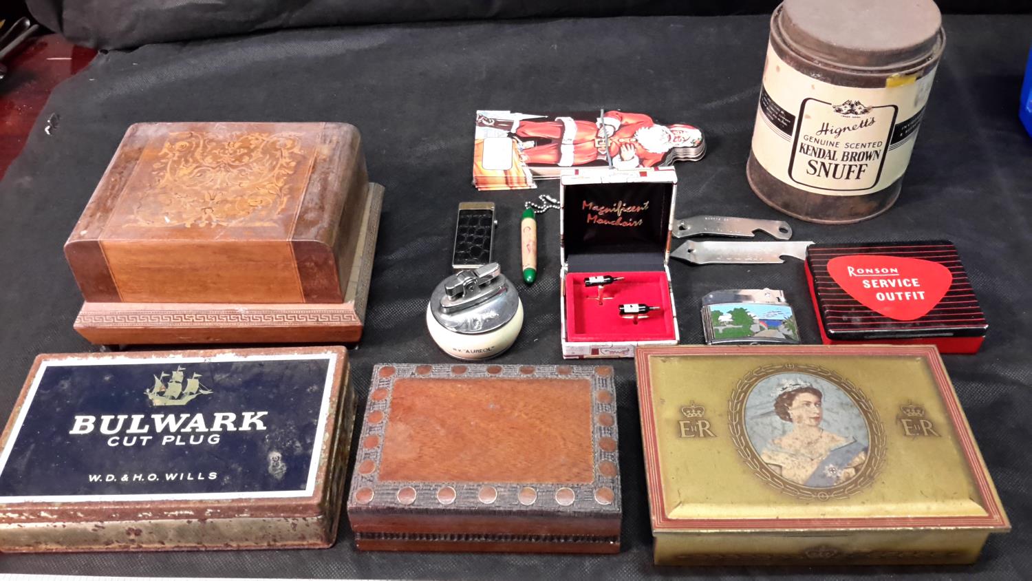 A collection of advertising tins, lighters & cigarette holder etc