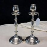 A pair of London silver candlesticks dated 1910, 23cm tall