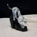 Fully faceted clear Swarovski Panther with unfaceted clear crystal tail, atop a cut black granite