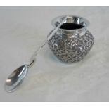 A white metal ornate pot (5cm in height) together with Birmingham silver jam spoon by Deakin &