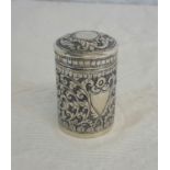 A white metal ornate lidded pot. 6.5cm in height