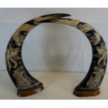 A pair of carved buffalo horns in an oriental design, 45cm in height