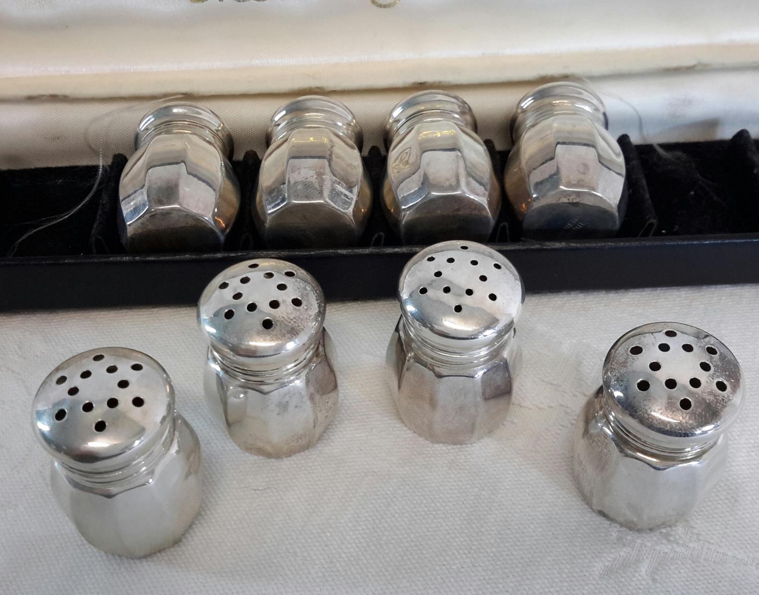 A set of 8 Empire sterling silver pepper pots