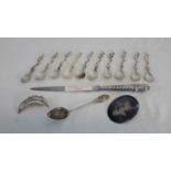 A collection of 800 grade and continental silver spoons, 925 leaf brooch, English silver handled