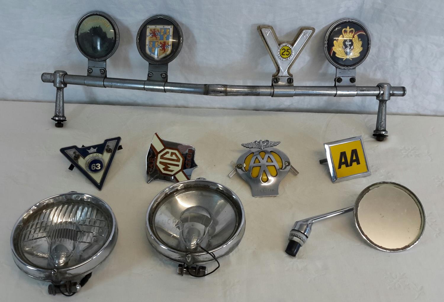 A collection of vintage car badges with bar, 2 Lucas head lamps & vintage mirror