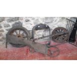 A collection of vintage car parts to include Ford radiator cover, 2 wheels, 2 windscreen frames &
