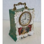 Henry Marc Paris clock in its gilted porcelain casing, has hand painted couple scene, green and gilt