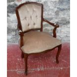 A 20th century button back, material arm chair