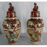 A Pair of early 1900's Japanese temple jar vases with lids. Both hand painted with foo dogs to the