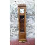 A 1920's oak long cased grandfather clock with bevel glass front with weights & pendulum