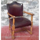 The mid 20th century oak framed arm chair with leather upholstery & stud detail
