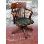 Antique captains chair with spindle back & green leather upholstery, 84cm in height