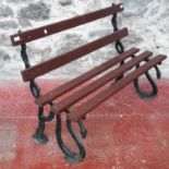 A Victorian cast iron bench with wooden slats (bench ends depict a snake), 78x122x58cm