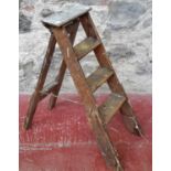 A set of 4 wooden step ladders