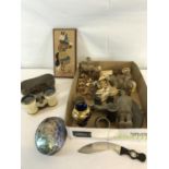 A box of mixed collectables to include Indian carvings, Bone Binoculars, Paua shell & Sand paintings