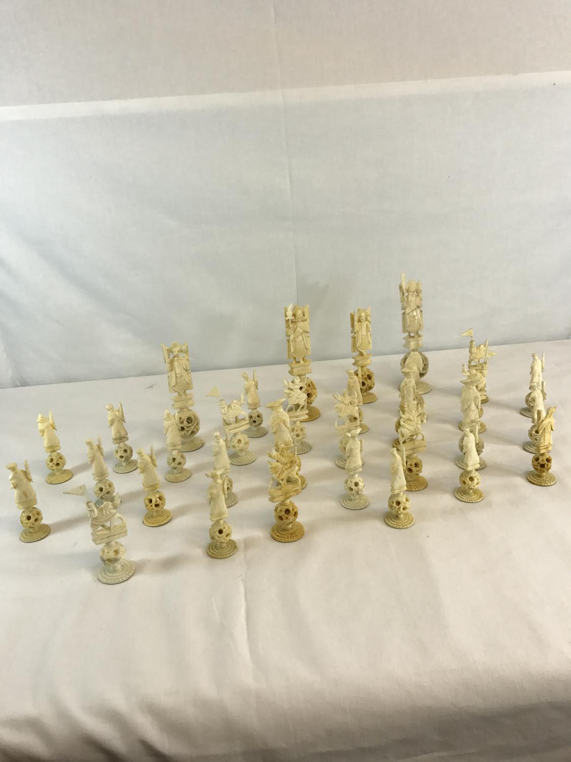 A collection of Oriental hand carved bone puzzle ball chess pieces