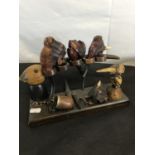 A collection of novelty carved smoking pipes on a novelty stand