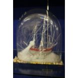 A Stourbridge glass frigger of a sailing ship, mid 19th Century, modelled beside a lighthouse and