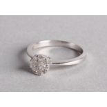 An 18ct white gold and diamond cluster ring, 3.4g in total Additional VAT of 20% will also be