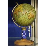 A painted metal globe with blue and white ceramic stem and wood base (af)