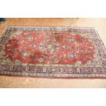 A red Persian rug (damage) 134 x 208cm and another Tabriz style rug