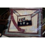 A quantity of Masonic items to include a locket on a silver chain, medals and a painting