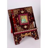 A Helene Angeli (handbag designer) photograph album, covered in red velvet, filigree gilt and semi