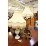 A pair of Tiffany style lamps, together with two gilt lamps and another (sold as parts)