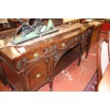 A Georgian style mahogany serpentine sideboard with three frieze drawers and two cupboards decorated