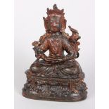 A bronze Sino Tibetan Buddha with traces of gold leaf sat on a double lotus throne, 15cm high.