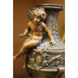 A pair of spelter urns, decorated with cherubs, 32cm high and a pair of Japanese Satsuma vases (4)