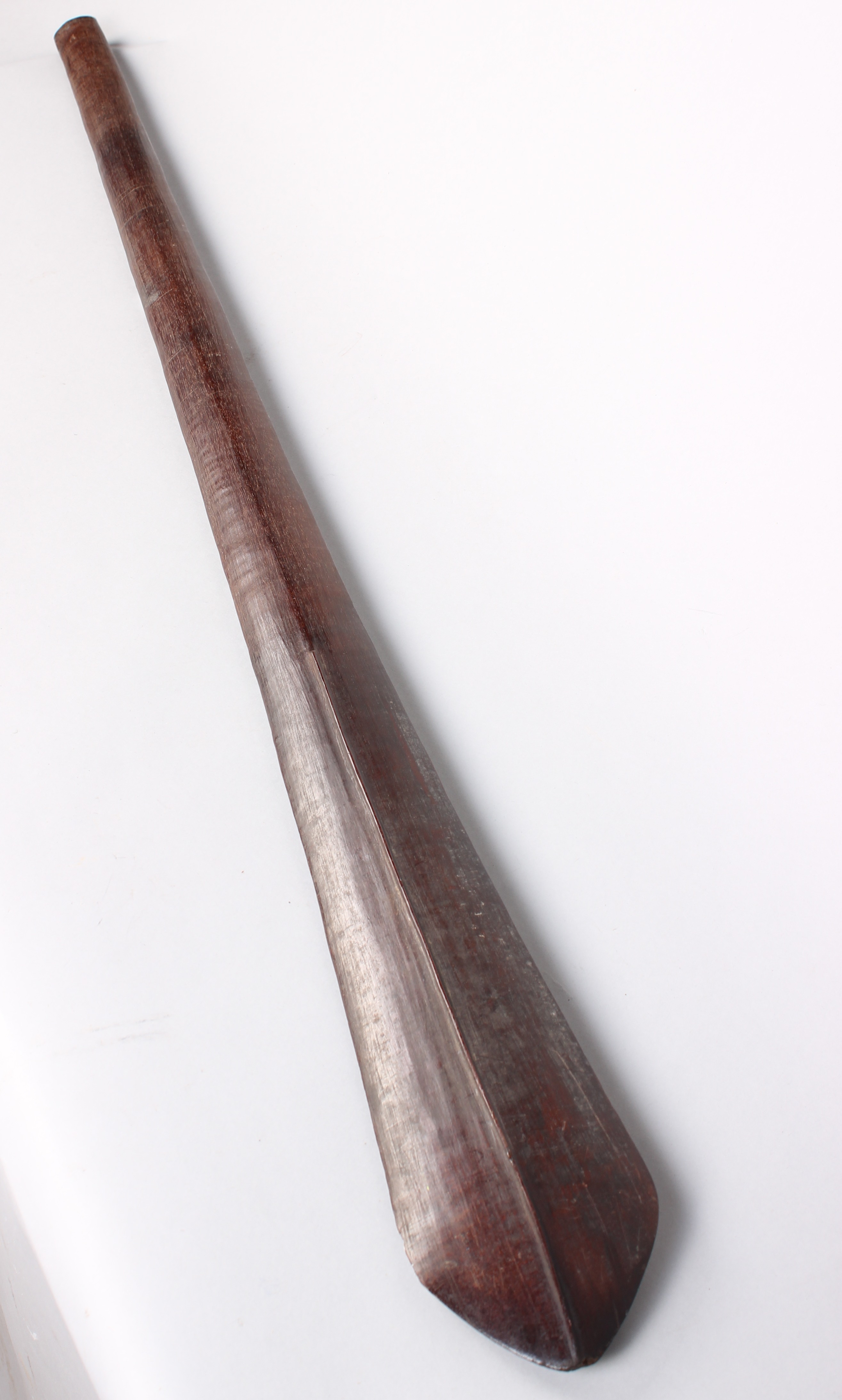 A Solomon island wooden paddle club, of eliptical spatulate form with medial ridges to the blade,