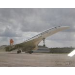 Photograph of Concorde taking off Signed lower right 'Brian Trubshaw', the first test pilot of