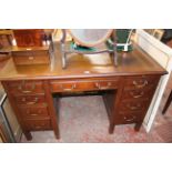 A Victorian mahogany kneehole desk with inset writing surface and nine drawers 122cm wide