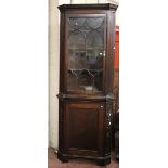 A mahogany standing corner cabinet in George III style 214cm high, 80cm wide