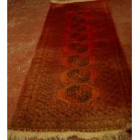 An Afghan carpet 107cm x 270cm