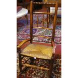 A 19th Century spindle back rocking chair with rush seat