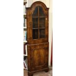 A walnut standing corner cabinet in Queen Anne style 182cm high, 59cm wide