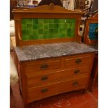 An Edwardian tile back wash stand, with a marble top, two short and two long drawers 108cm wide