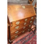 An 18th Century oak bureau with a fitted interior and four long drawers 95cm wide